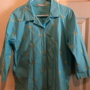 Blue shirt with sea turtle designs.